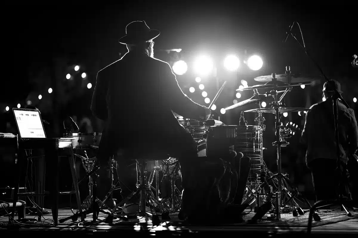 Coulisses d'un concert: mains, câbles et lumière stroboscopique